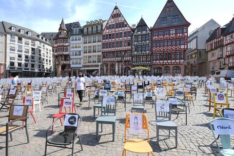 Mit leeren Stühlen demonstrieren Frankfurter Gastronomen auf dem Römerberg und machen auf die kritische Lage von Gaststätten und Hotels in der Corona-Krise aufmerksam.  Foto: dpa
