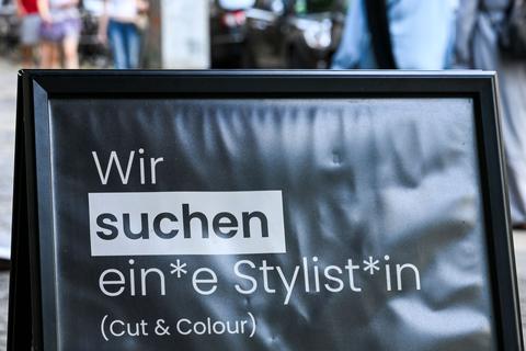 Mehrgeschlechtliche Suche nach Personal auf einem Schild in Berlin.